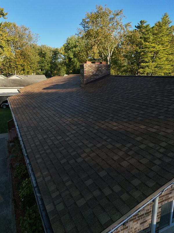 Shingle roof with a brick chimney