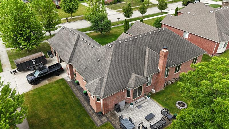 Brick ranch with patio and new gray roof