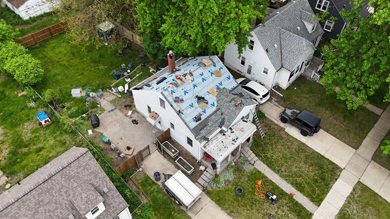 Tear-off in progress on a two-story home