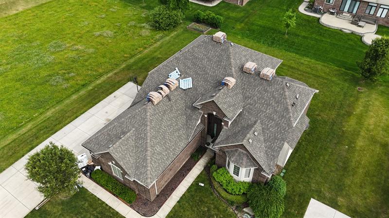 Hip roof with dormers on a large home