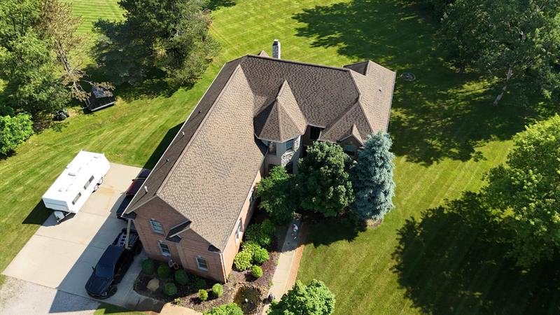 Brick home with a new tan roof