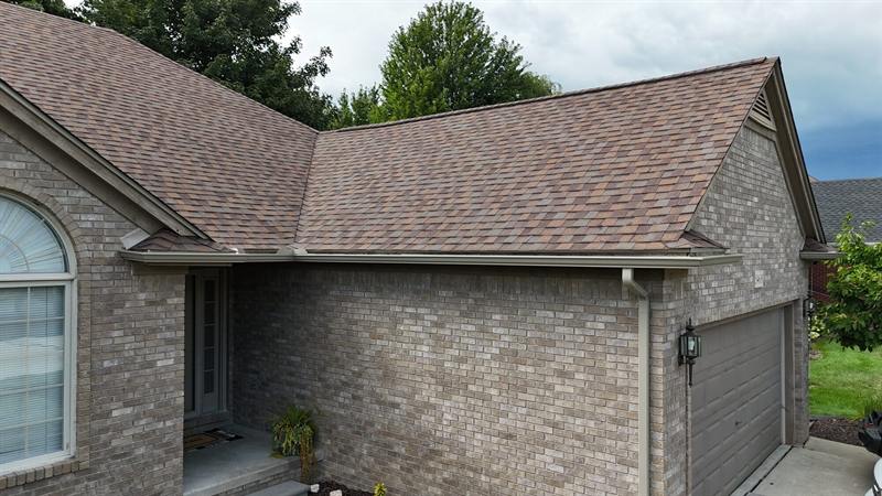 New shingles above a brick wall