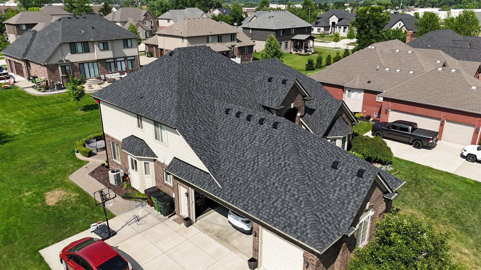 Large two-story home with a new charcoal roof, from a drone