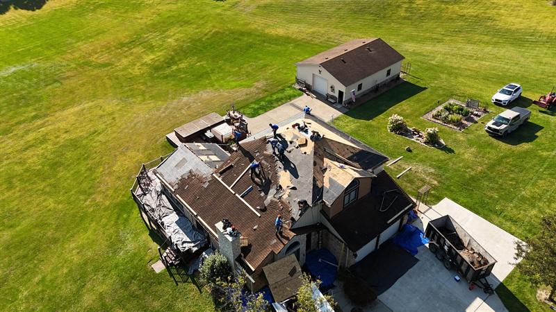 Tear-off in progress on a rural home