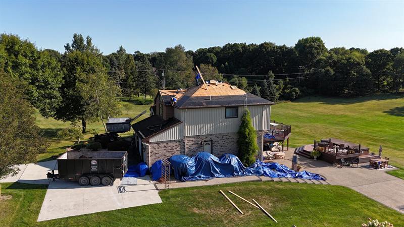 Job site with tarps and dump trailer